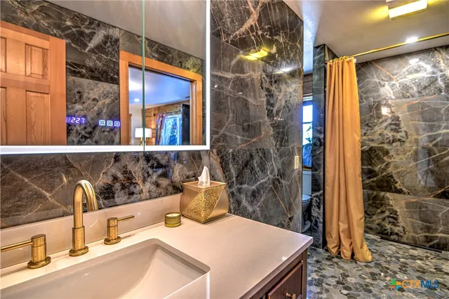 a bathroom with a sink and a mirror