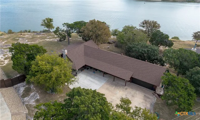 an aerial view of a house with a yard