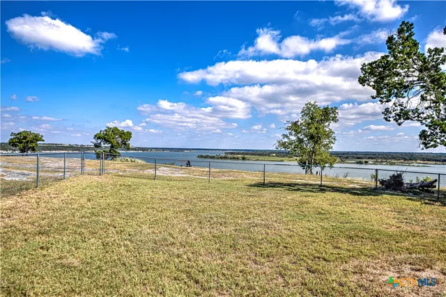 a view of a lake with a yard