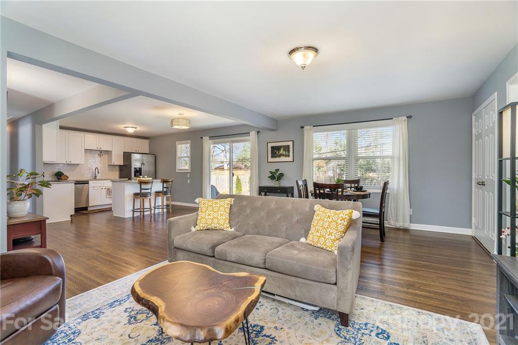 4235 Sudbury Road Charlotte, NC 28205 - Photo 11 of 29 a living room with furniture wooden floor and a large window