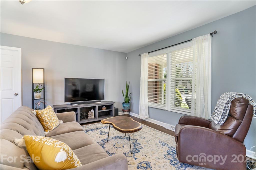 4235 Sudbury Road Charlotte, NC 28205 - Photo 13 of 29 a living room with furniture and a flat screen tv