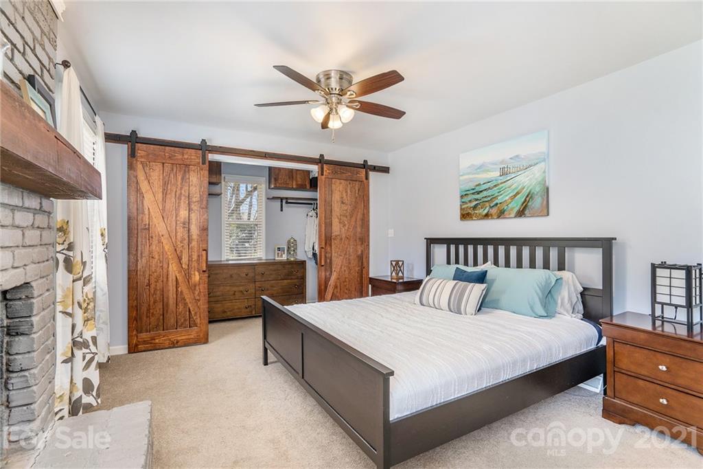 4235 Sudbury Road Charlotte, NC 28205 - Photo 14 of 29 a bedroom with a large bed and a chandelier