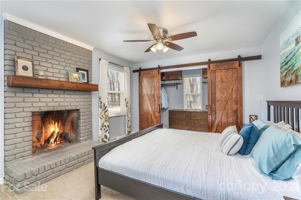 4235 Sudbury Road Charlotte, NC 28205 - Photo 15 of 29 a bedroom with a bed and a fireplace