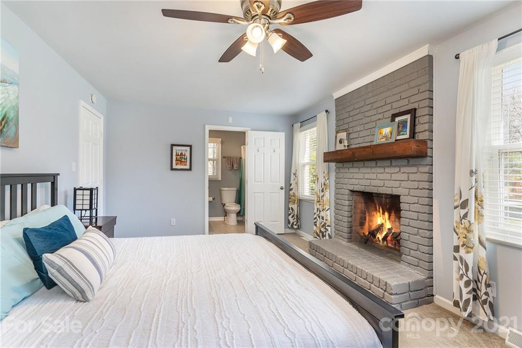4235 Sudbury Road Charlotte, NC 28205 - Photo 16 of 29 a bedroom with a bed and a fireplace