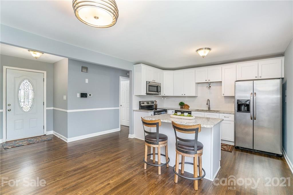 4235 Sudbury Road Charlotte, NC 28205 - Photo 3 of 29 a view of kitchen with cabinets and wooden floor