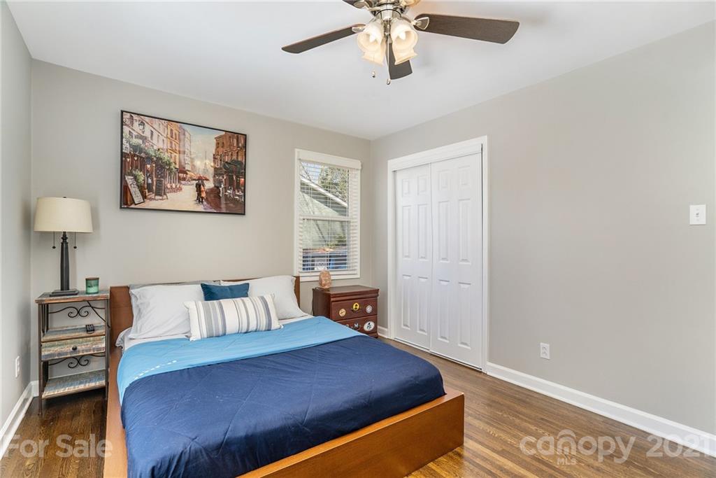 4235 Sudbury Road Charlotte, NC 28205 - Photo 21 of 29 a bedroom with a bed and dresser