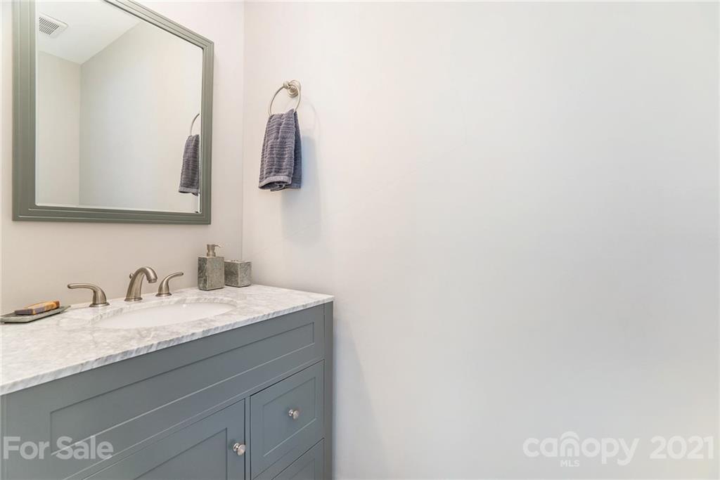 4235 Sudbury Road Charlotte, NC 28205 - Photo 23 of 29 a bathroom with a sink and a mirror