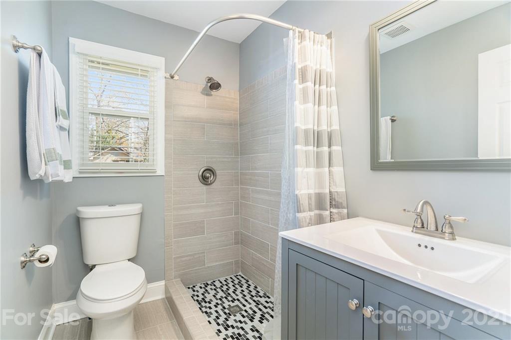 4235 Sudbury Road Charlotte, NC 28205 - Photo 26 of 29 a bathroom with a sink toilet and shower