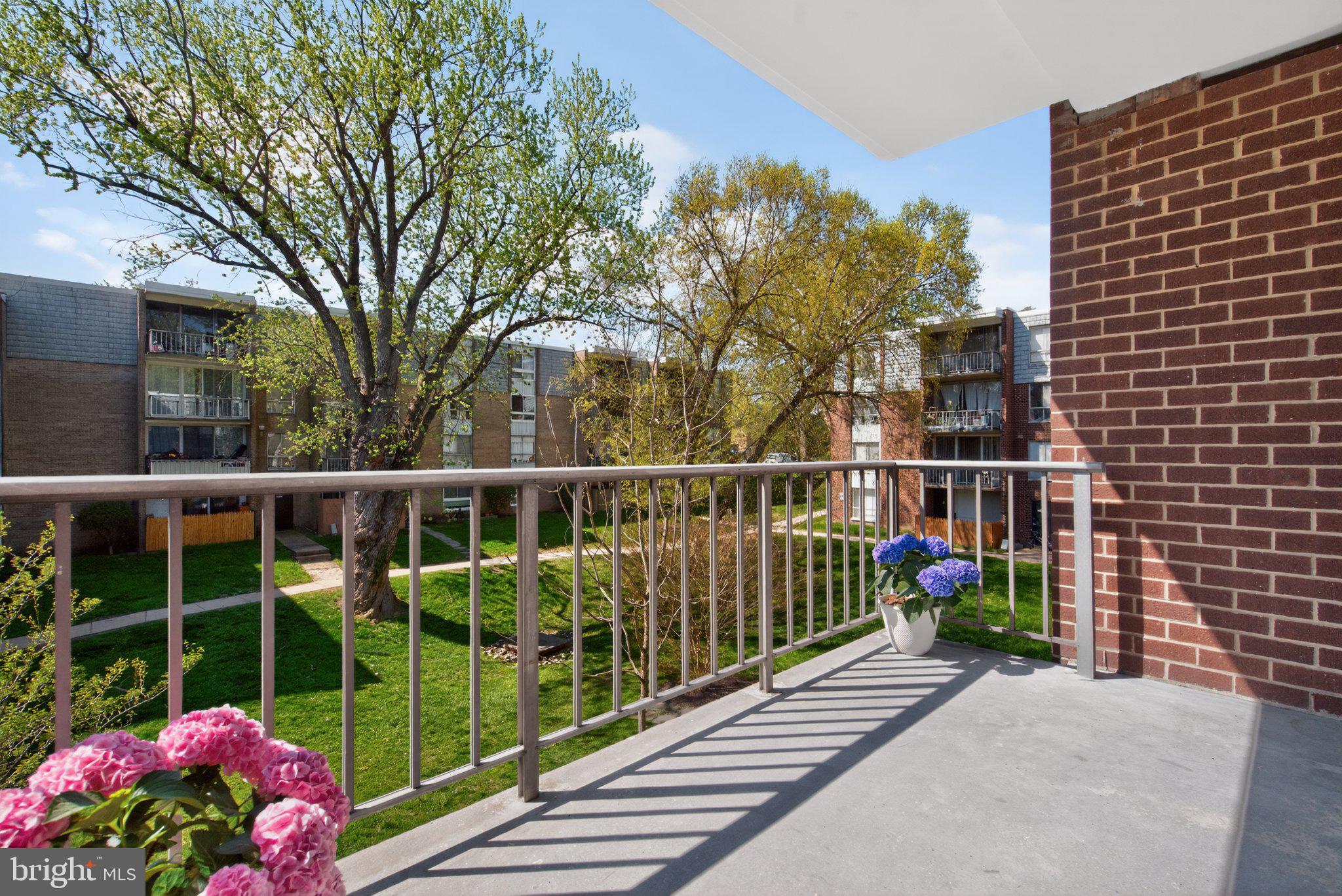 3932 Bel Pre Road, Unit 39326 Silver Spring, MD 20906 - Photo 12 of 20 Sunny balcony with vibrant greenery.