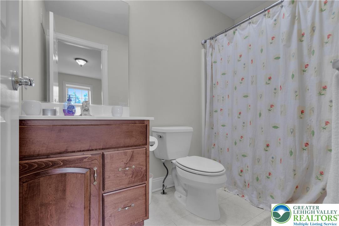 774 Lahr Road Nazareth, PA 18064 - Photo 32 of 58 a bathroom with a sink a toilet a mirror and shower curtain