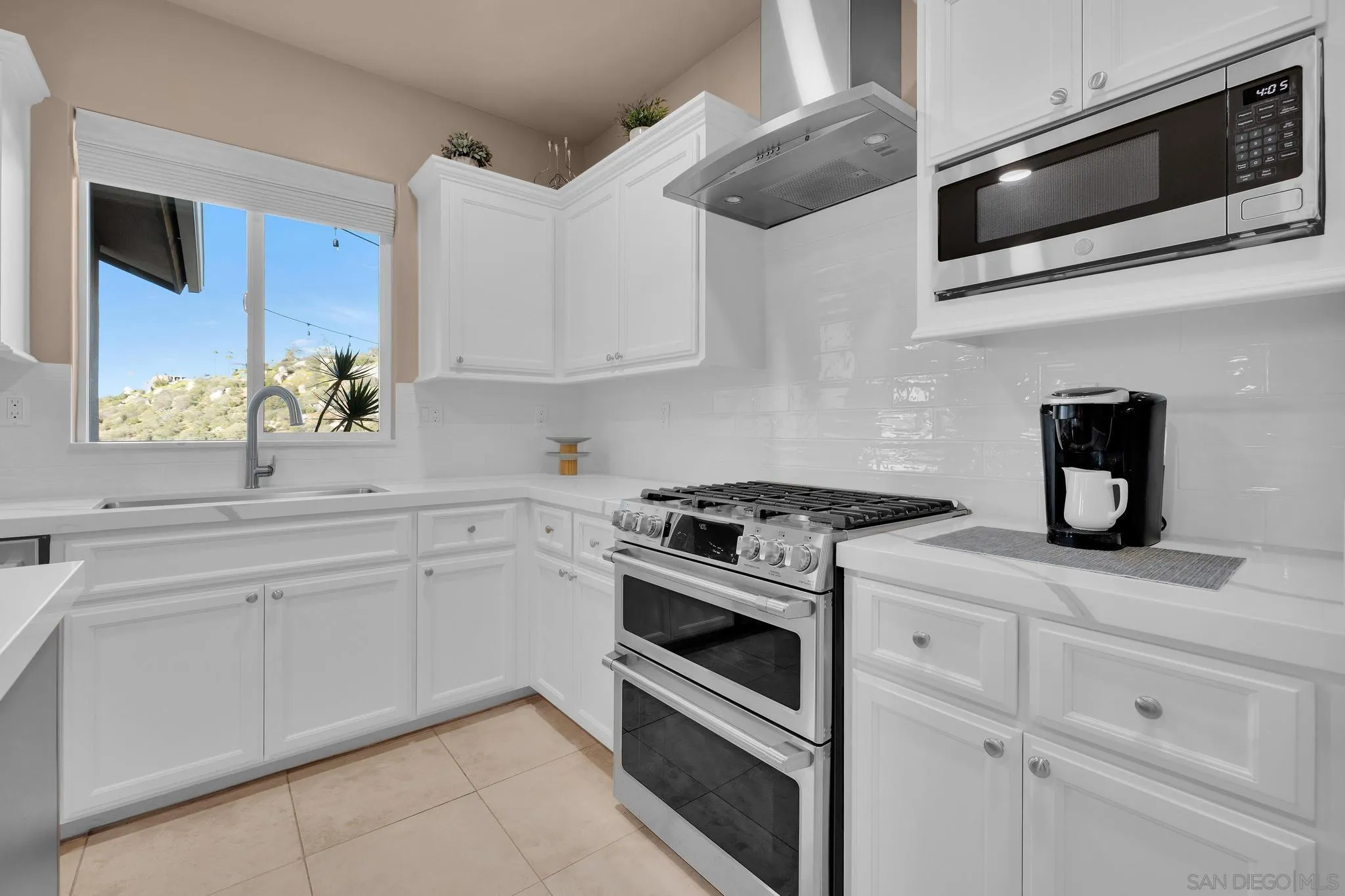 578 North Alpine Trail Road Alpine, CA 91901 - Photo 12 of 50 a kitchen with stainless steel appliances granite countertop white cabinets and window