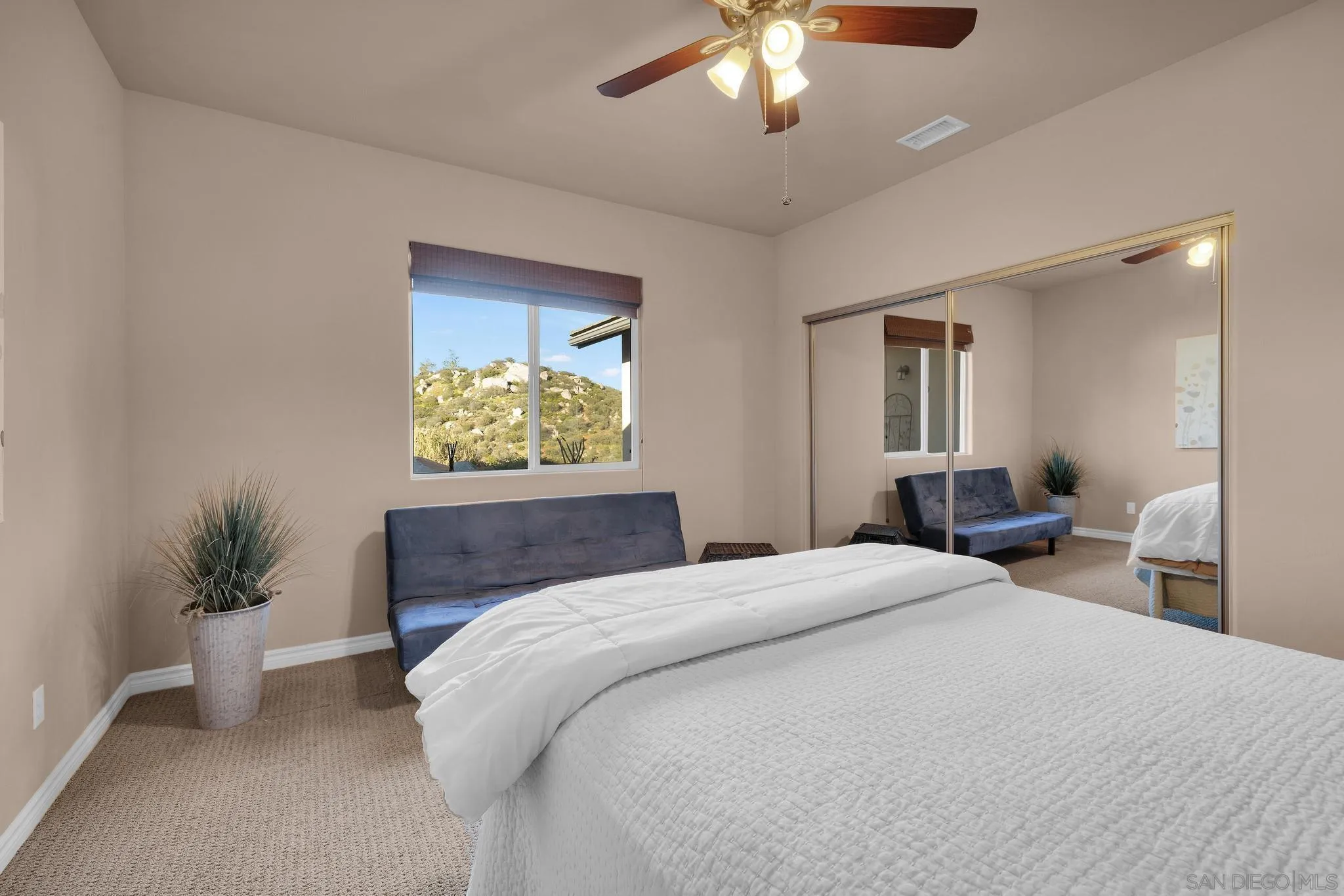 578 North Alpine Trail Road Alpine, CA 91901 - Photo 25 of 50 a bedroom with a large bed and a chandelier