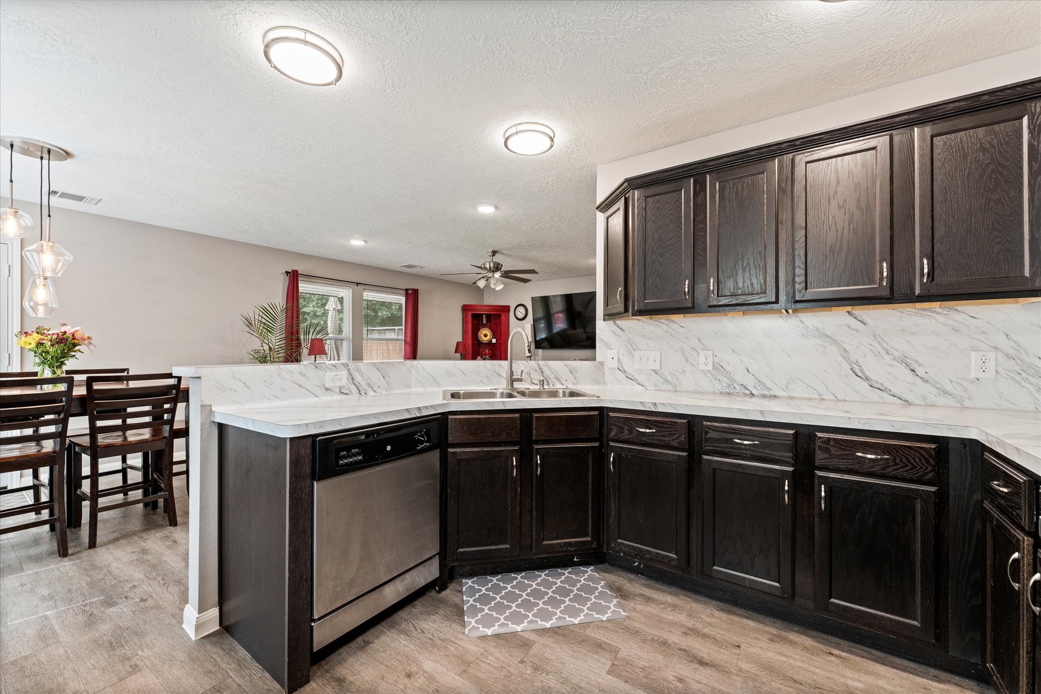 3998 Frontier Road Willis, TX 77378 - Photo 24 of 33 a kitchen with a stove sink and cabinets