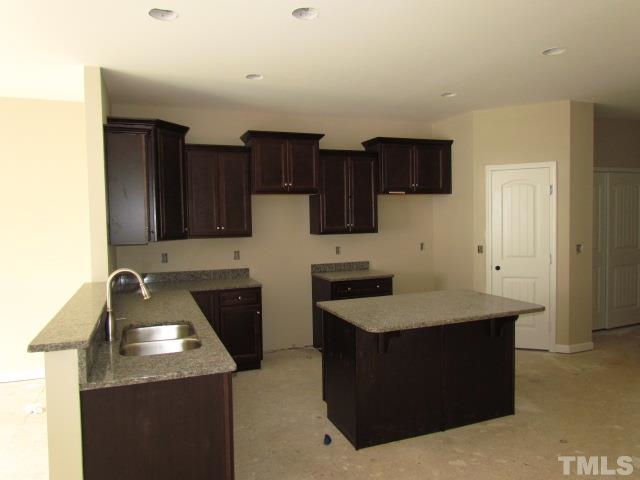 4623 Pat Reed Road Raleigh, NC 27616 - Photo 5 of 13 a kitchen with a sink stove and refrigerator