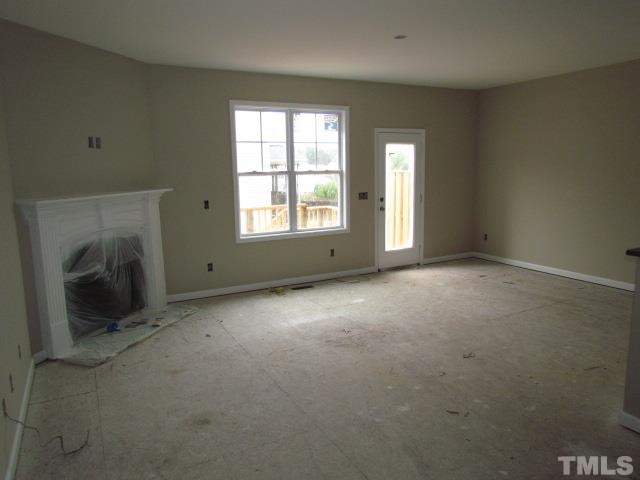4623 Pat Reed Road Raleigh, NC 27616 - Photo 6 of 13 an empty room with a fireplace and a window
