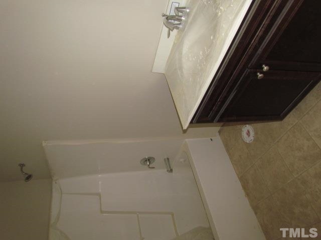 4623 Pat Reed Road Raleigh, NC 27616 - Photo 10 of 13 a bathroom with a bathtub