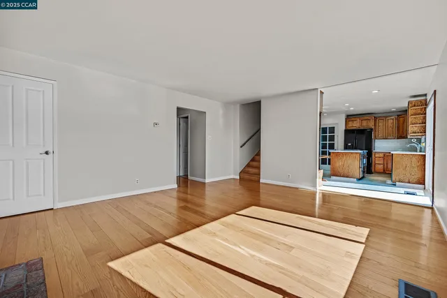 a kitchen with stainless steel appliances kitchen island granite countertop a refrigerator and a stove top oven with a dishwasher