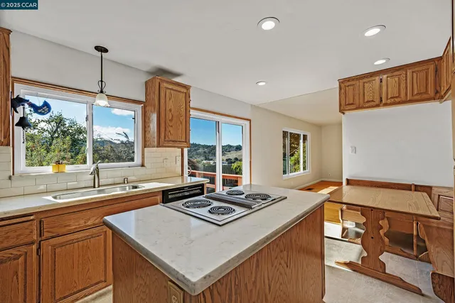 a kitchen with a stove a sink and a refrigerator