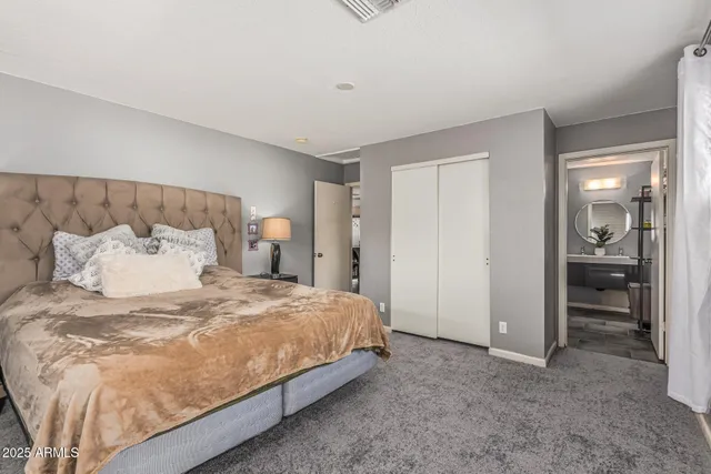 a large bed sitting in a bedroom and table