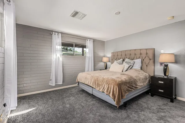 a bedroom with a bed and a night stand