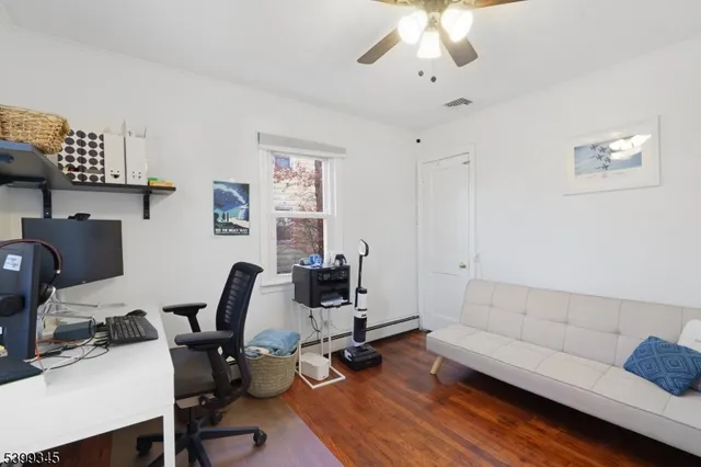 a work room with furniture and wooden floor
