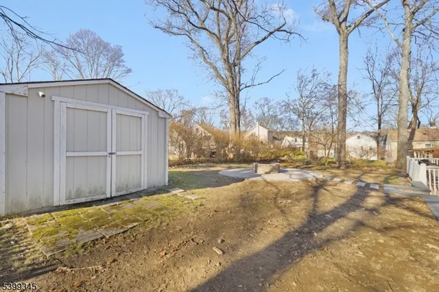 a view of yard covered with snow in front of house