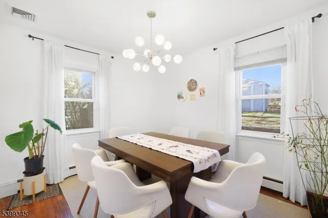 a view of a dining room with furniture and chandelier