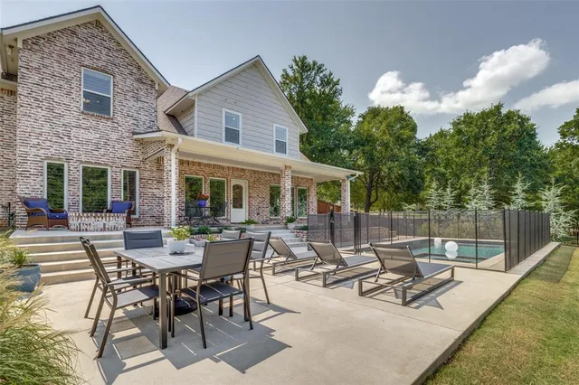 a view of a house with backyard sitting area and garden