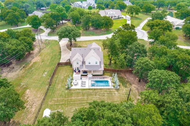 an aerial view of residential house with outdoor space and swimming pool