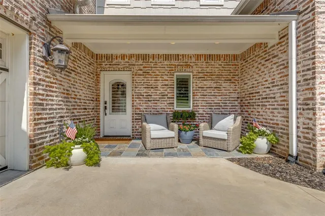 a front view of a house with outdoor seating
