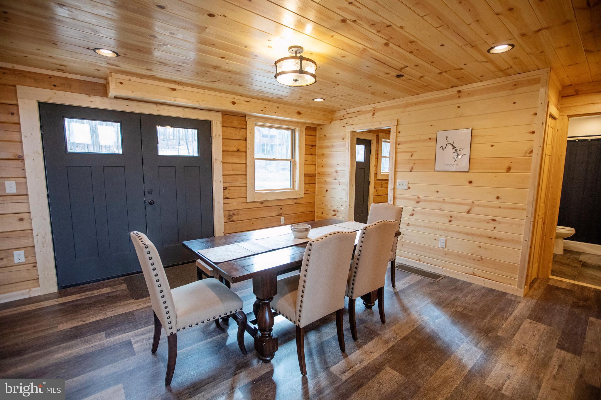 635 Biltmore Rdg Trail McHenry, MD 21541 - Photo 15 of 64 a view of a dining room with furniture window and wooden floor