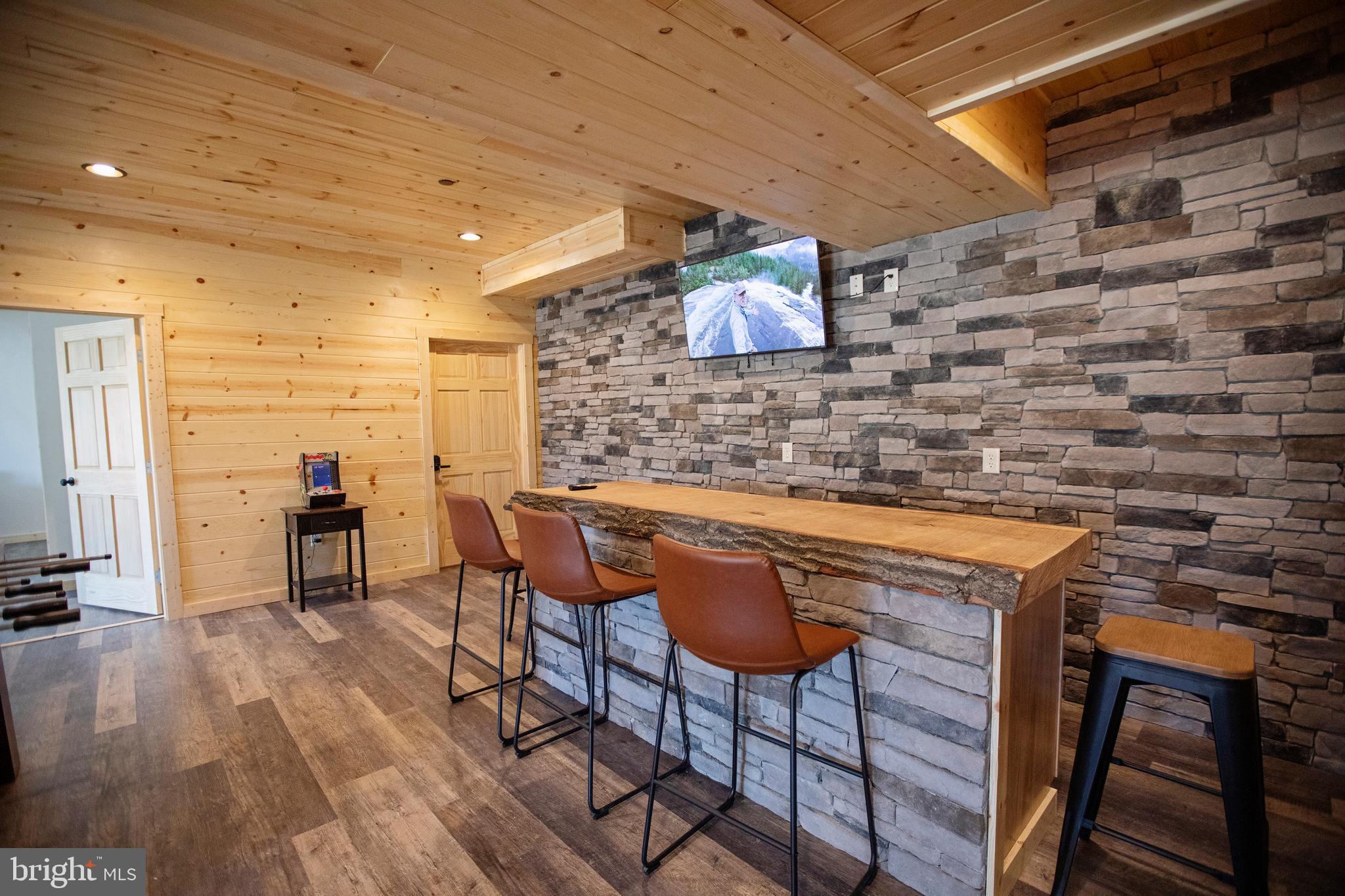 635 Biltmore Rdg Trail McHenry, MD 21541 - Photo 40 of 64 a kitchen with table chairs sink and wooden floor