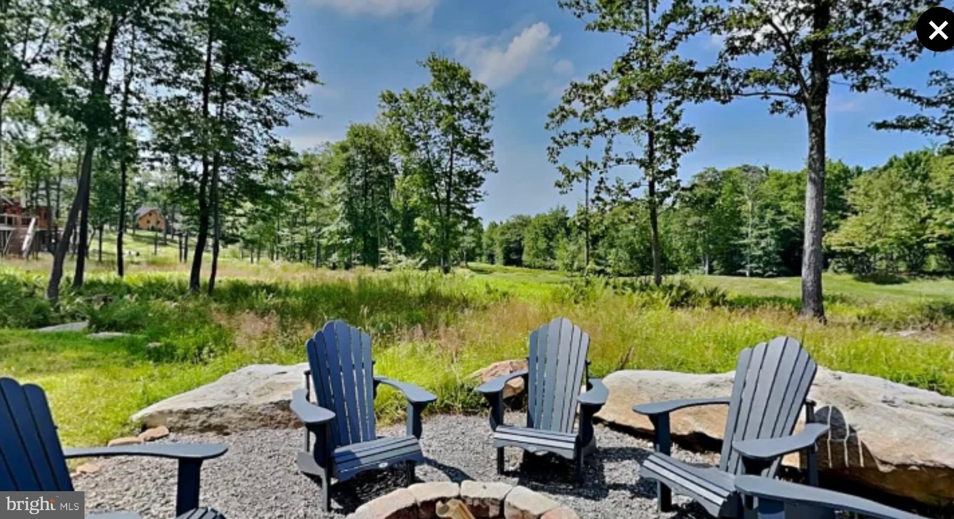635 Biltmore Rdg Trail McHenry, MD 21541 - Photo 62 of 64 a view of a lake with table and chairs next to a yard