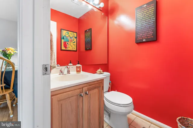 a bathroom with a toilet a sink and a mirror