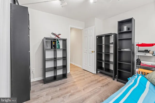 a view of empty room with wooden floor and closet