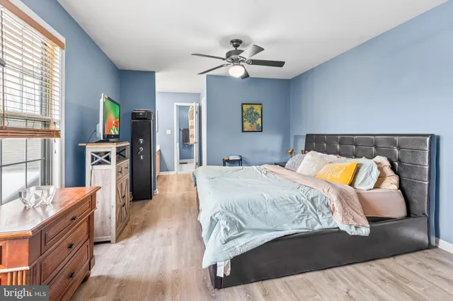 a bedroom with a bed and wooden floor