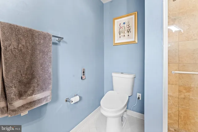 a white toilet sitting next to a bathroom sink