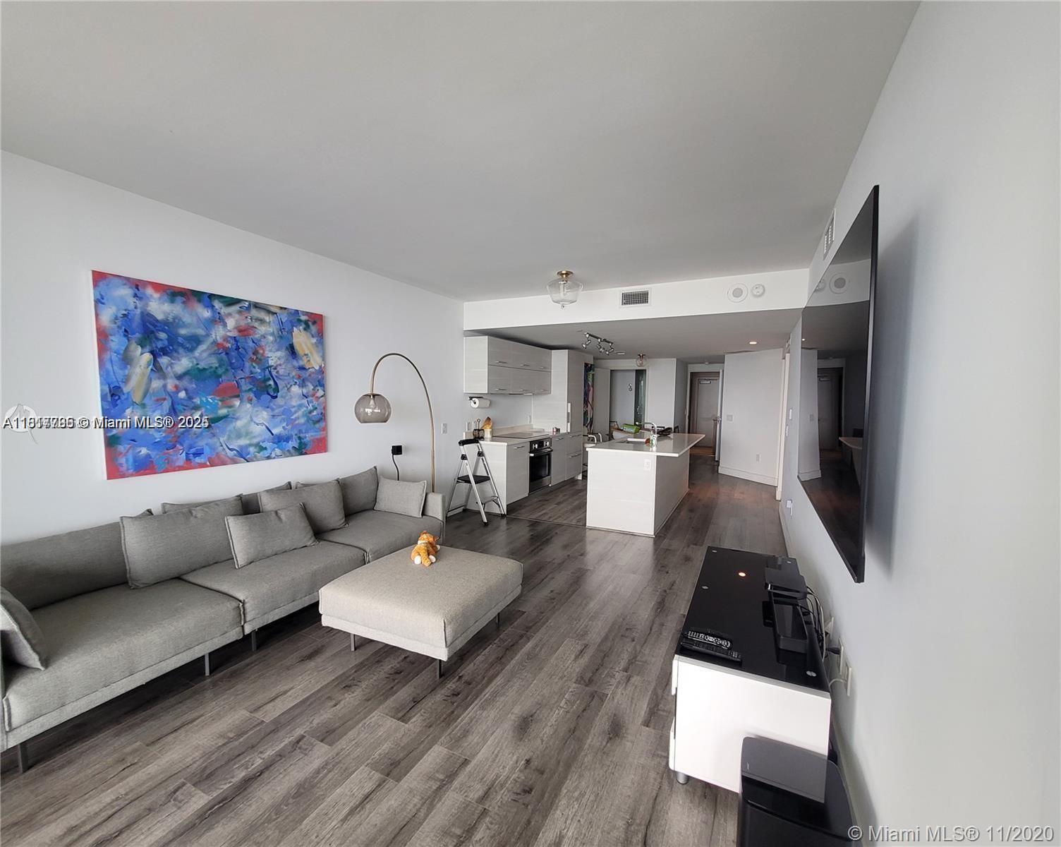 Edgewater Miami, FL 33137 - Photo 2 of 11 a living room with furniture and a flat screen tv
