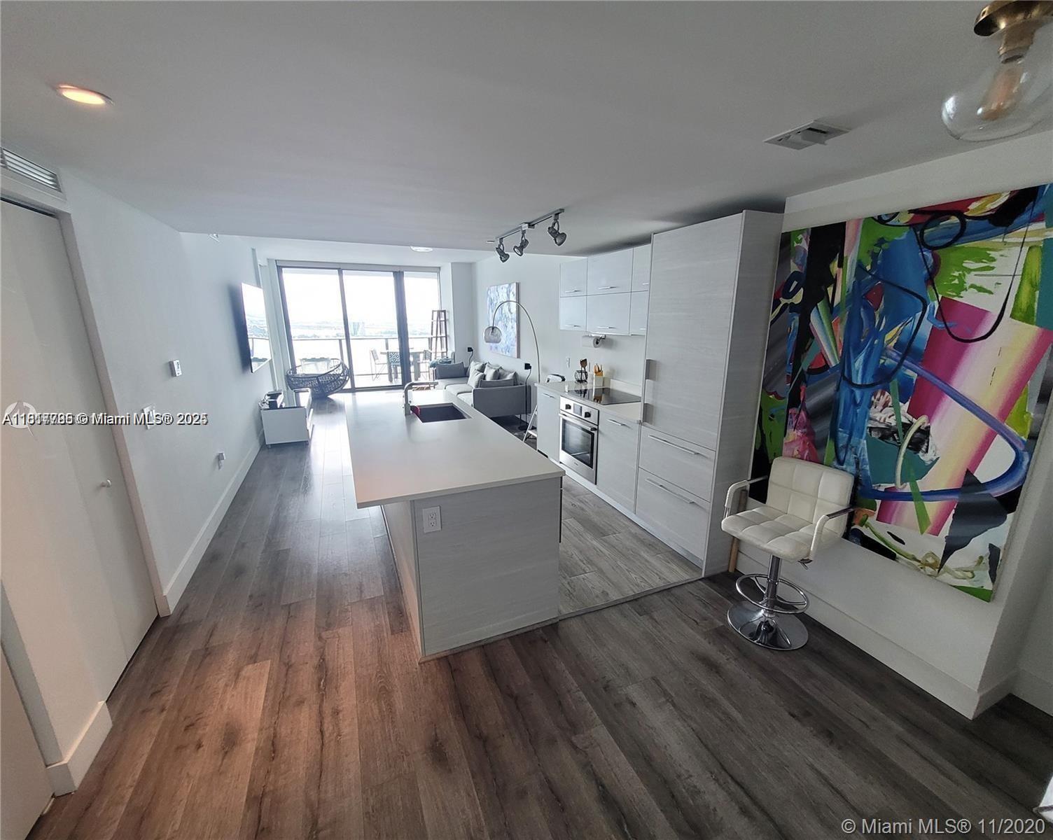 Edgewater Miami, FL 33137 - Photo 3 of 11 a living room with furniture and a wooden floor