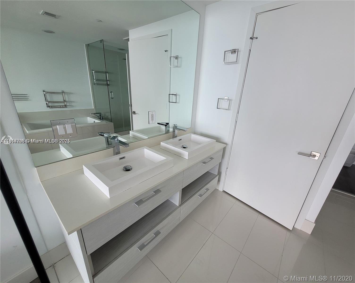 Edgewater Miami, FL 33137 - Photo 10 of 11 a bathroom with a sink a mirror and a bathtub