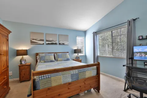 a bed room with a bed and a window