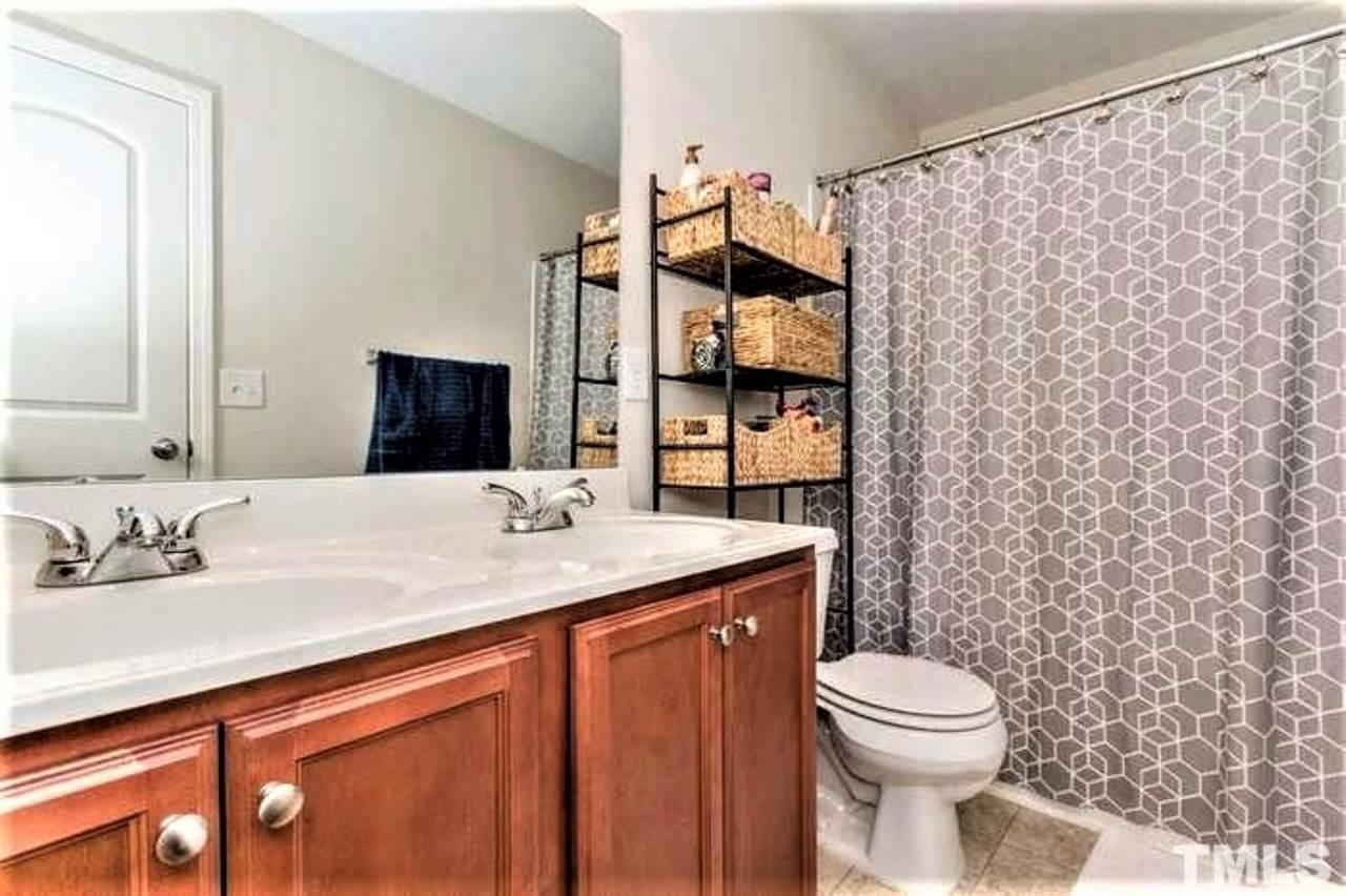 2737 Manthorp Terrace Raleigh, NC 27610 - Photo 17 of 21 a bathroom with a granite countertop sink mirror vanity and toilet