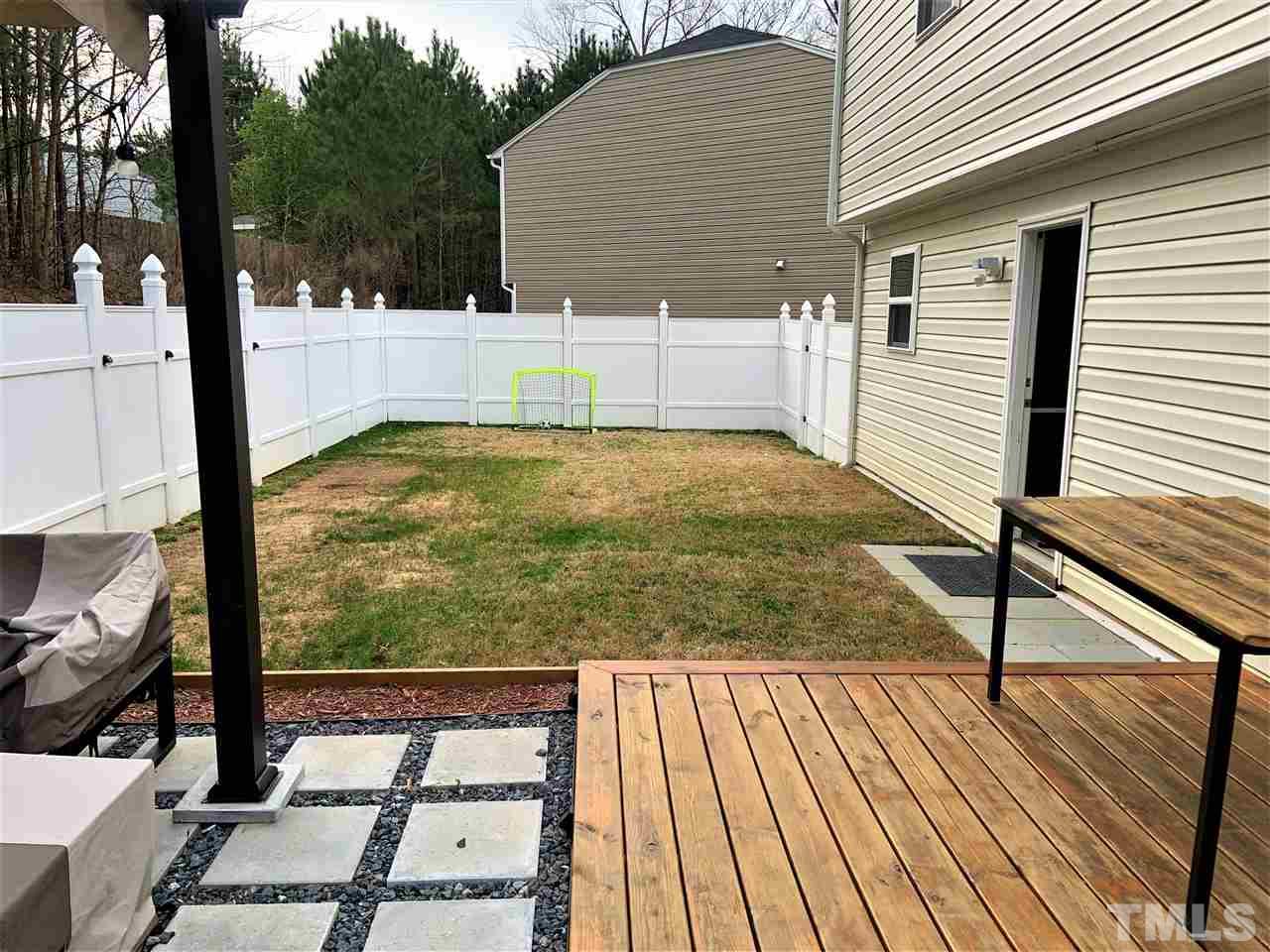2737 Manthorp Terrace Raleigh, NC 27610 - Photo 20 of 21 a view of a balcony with floor to ceiling windows with wooden floor
