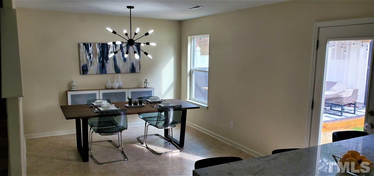 2737 Manthorp Terrace Raleigh, NC 27610 - Photo 9 of 21 a view of a dining room with furniture and chandelier