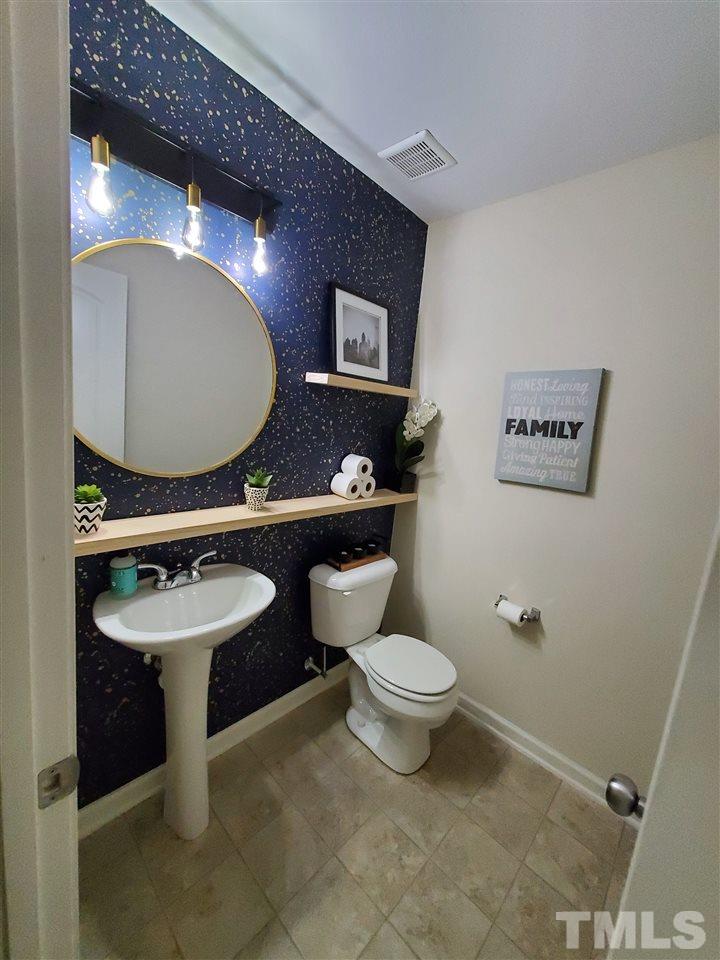 2737 Manthorp Terrace Raleigh, NC 27610 - Photo 10 of 21 a bathroom with a sink mirror toilet and a mirror