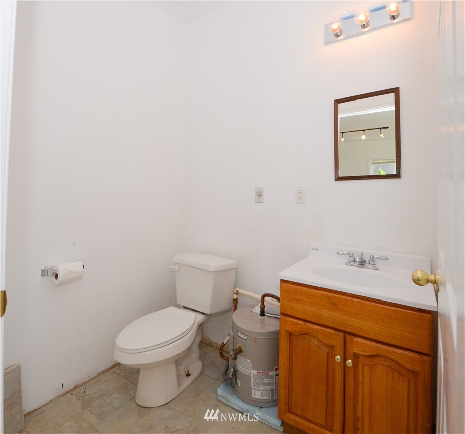 17707 Jordan Street Southwest Rochester, WA 98579 - Photo 16 of 23 a white toilet sitting next to a bathroom sink