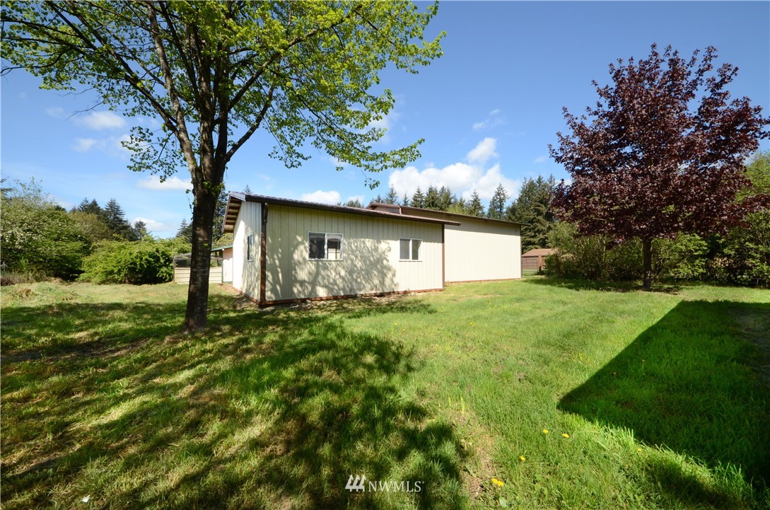 17707 Jordan Street Southwest Rochester, WA 98579 - Photo 22 of 23 a backyard of a house with plants and tree