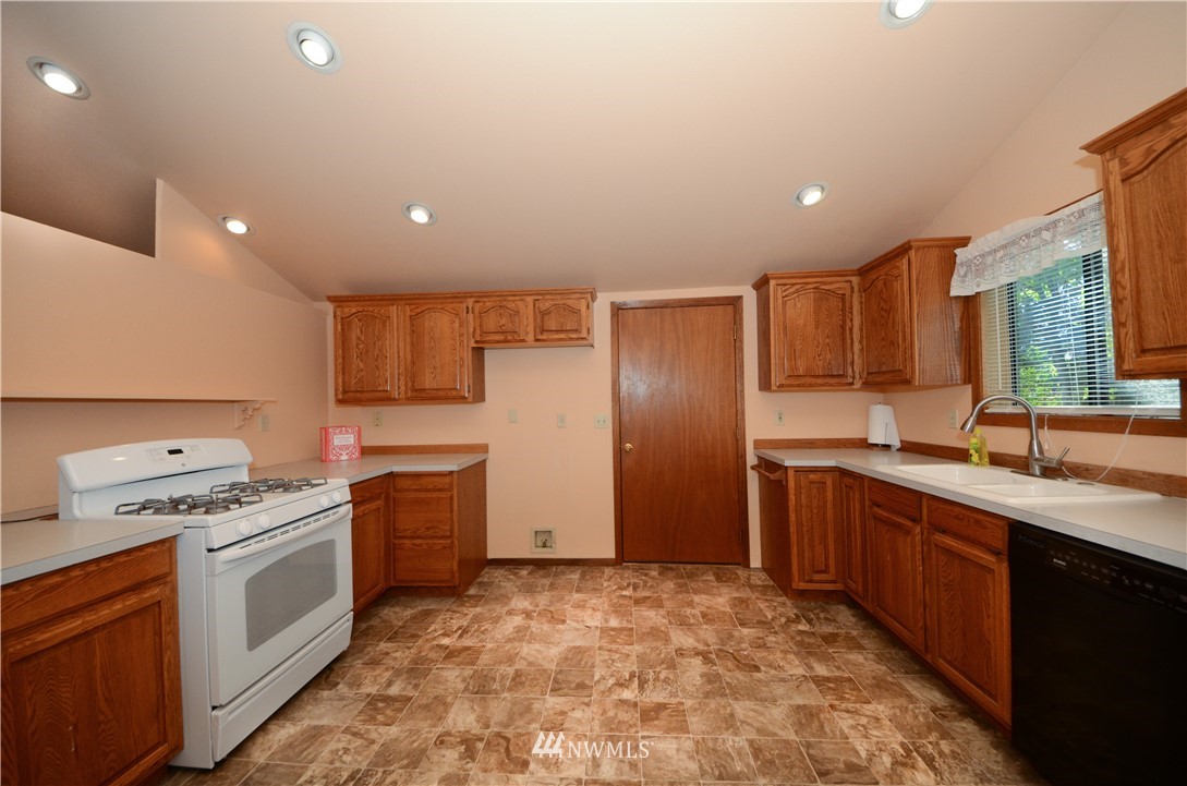 17707 Jordan Street Southwest Rochester, WA 98579 - Photo 5 of 23 a kitchen with stainless steel appliances granite countertop a sink stove and refrigerator