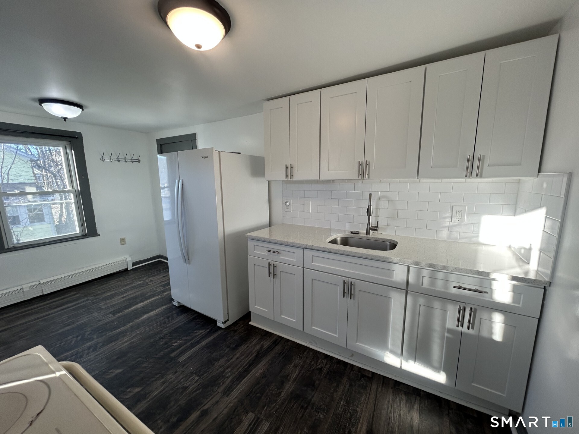 a kitchen with stainless steel appliances granite countertop a refrigerator sink and cabinets