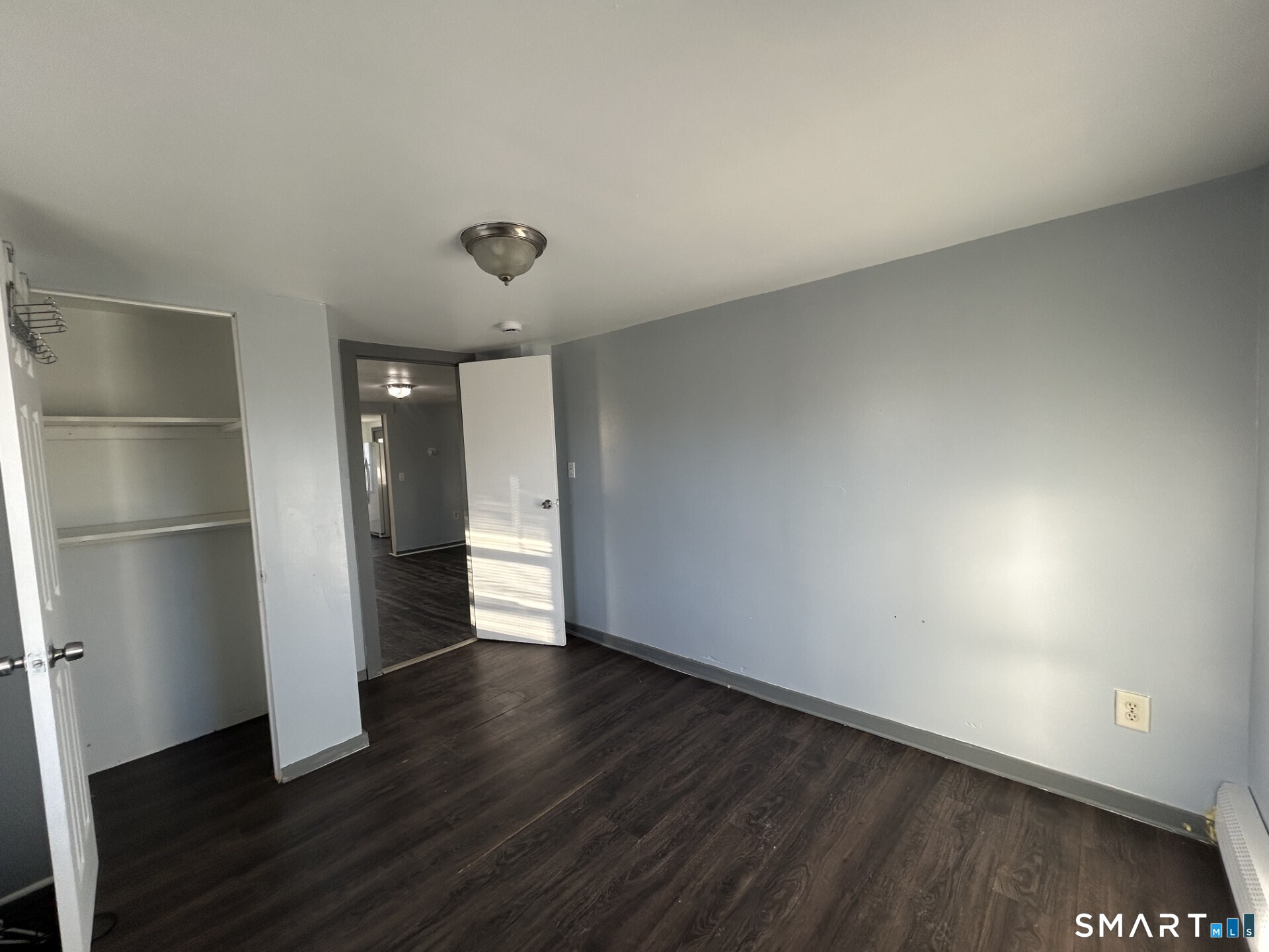 288 Litchfield Street, Unit 2 Torrington, CT 06790 - Photo 11 of 15 a view of an empty room with wooden floor and closet